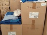 a pile of boxes with clothes on top of them
