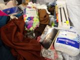 a pile of clothes and other items on a bed