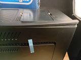 an image of a black computer with a blue tag on it