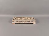 an old wooden box sitting on top of a white table