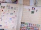 a open book with stamps on it sitting on a table