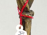 a small statue of a bird on a tree