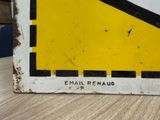 a yellow and black sign on a wooden table