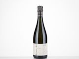 a bottle of wine sitting on top of a white table