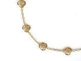 a close up of a gold necklace on a white background