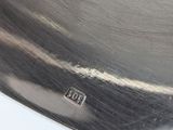 a close up of a metal object on a white surface
