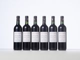 six bottles of wine are lined up on a table