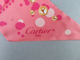 a pink bandana with white polka dots on it