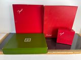 two red boxes and a green box are sitting on a table