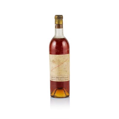 a bottle of wine sitting on top of a white surface