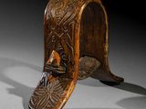 a close up of a wooden object with carvings on it