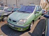 a green car parked in a parking lot next to other cars