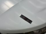 a sticker on the hood of a white car