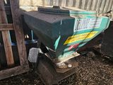 a small tractor that is parked next to a fence