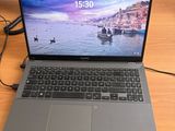 a laptop that is sitting on a desk with a phone on it
