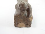 a small statue of a woman sitting on a rock