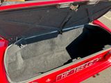 a trunk of a red car with the door open