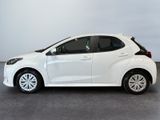a white car is parked in a room with a gray floor