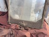 a mirror sitting on top of a blanket on the ground