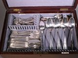 a wooden box with silverware in it on a table