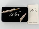 an image of a pen sitting on top of a box next to a card