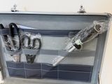 a suitcase with scissors and other items inside of it