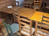 tables and chairs in a room with wood paneled walls