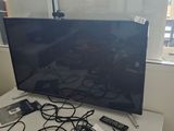 a flat screen tv sitting on top of a white table