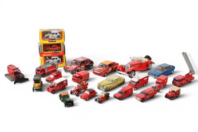 a lot of toy cars and trucks that are on a white surface