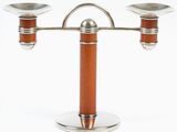 a silver and wood candle holder with two candles on it