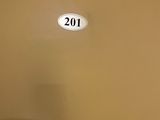a picture of a toilet in a bathroom with a number on the wall