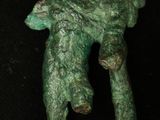 a green statue of a man holding a child