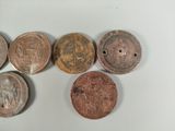 six different types of coins sitting on top of a white surface
