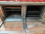 two ovens that are open in the kitchen