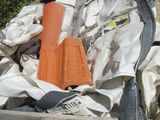 a pile of junk in the yard next to a fence