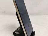 a close up of a cell phone on a stand on a table