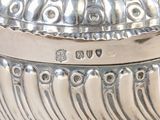 a silver bowl with a lid on a table