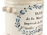 a small blue and white pot with a handle on it