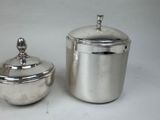 silver plated sugar and creamer with lid on white background