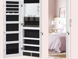 a white cabinet with a mirror and a mirror on the wall