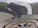 a reflection of a man in a car ' s side mirror