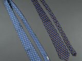 two ties are laying next to each other on a table