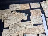 several pieces of old paper with writing on them sitting on a table