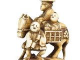 an image of a figurine of a man riding a horse with a child on his back
