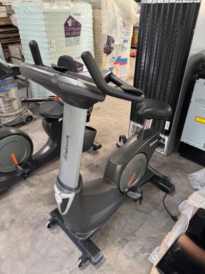 two stationary exercise bikes in a warehouse area