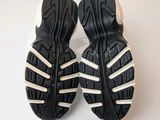 pair of black and white tennis shoes on a white surface