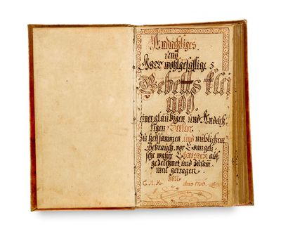 an old book with writing on it sitting open on a white surface