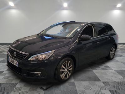 the black car is parked on a checkered floor in the garage