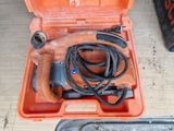 an orange tool box with a cord and a tool in it