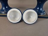 two blue vases sitting on top of a table